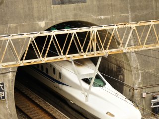 The shinkansen coming out of the tunnel which starts&nbsp;near Mount Rokko and exits just before the arrival at&nbsp;Shin Kobe Station. The picture was&nbsp;taken from the hiking trail starting point of Mount Maya.