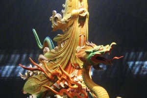 Kannon (Avalokitesvara) riding on a dragon. Wood and colour, 20th century