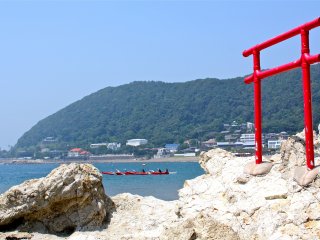 The torii gate at Isshiki Beach sits just on the rocky edge of the grassy isthmus