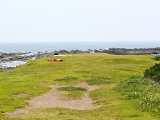The grassy isthmus that separates the two, crescent shaped beaches of Isshiki
