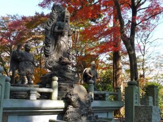 These statues of gods are striking against the fiery colors of the autumn leaves.