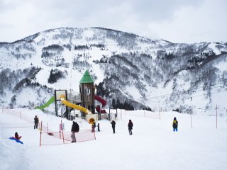 A playground right in the middle of snowy mountains