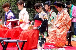 Locals dressed up as living figurines from a traditional Hina doll set