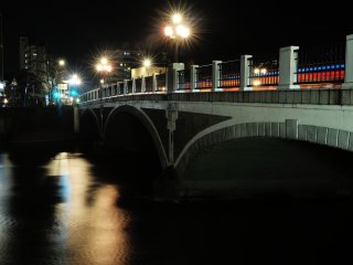 Lamp light spilling from Asano River Bridge