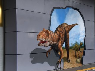 Trick art painting of Fukui-raptor on a wall of JR Fukui Station terminal building