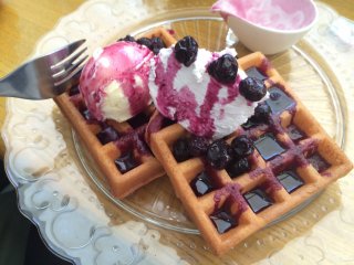 Delicious blueberry &nbsp;waffles with ice cream and whipped cream.