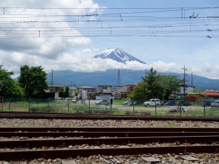 Walk around to the toilets end of the station building to get a clear shot of Mt. Fuji over the train tracks 