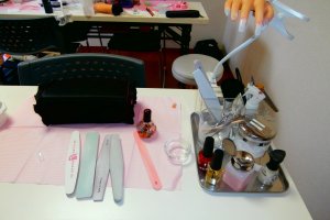 Students improve their skills by practicing with professional nail art tools
