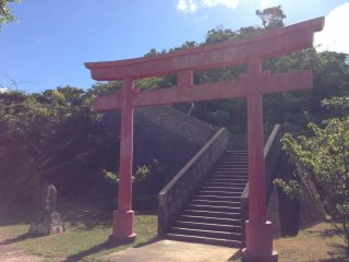 A large&nbsp;torii leads to a pathway winding up the hill