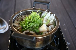 Nabekko hot pot with kiritanpo simmering alongside the veggies