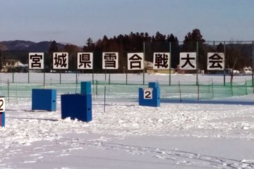 <p>On the backfield a sign reads Miyagi&nbsp;Prefecture Snowball Fight Tournament.&nbsp;</p>