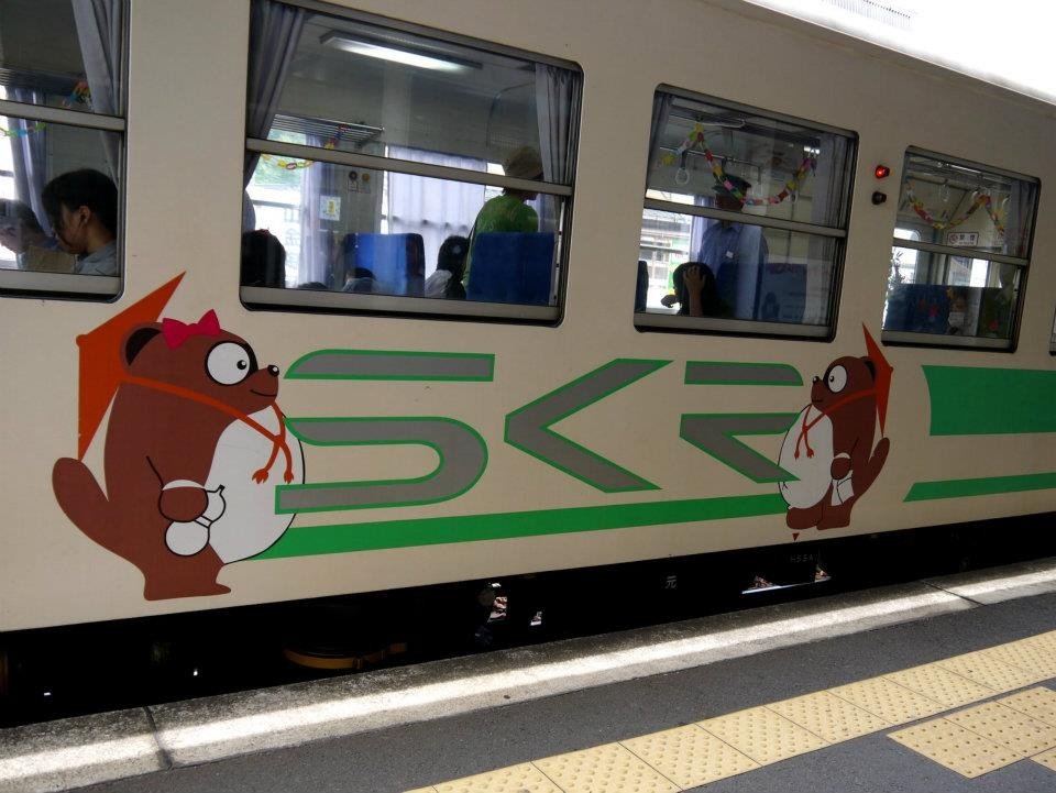 The small local train is decorated with tanuki