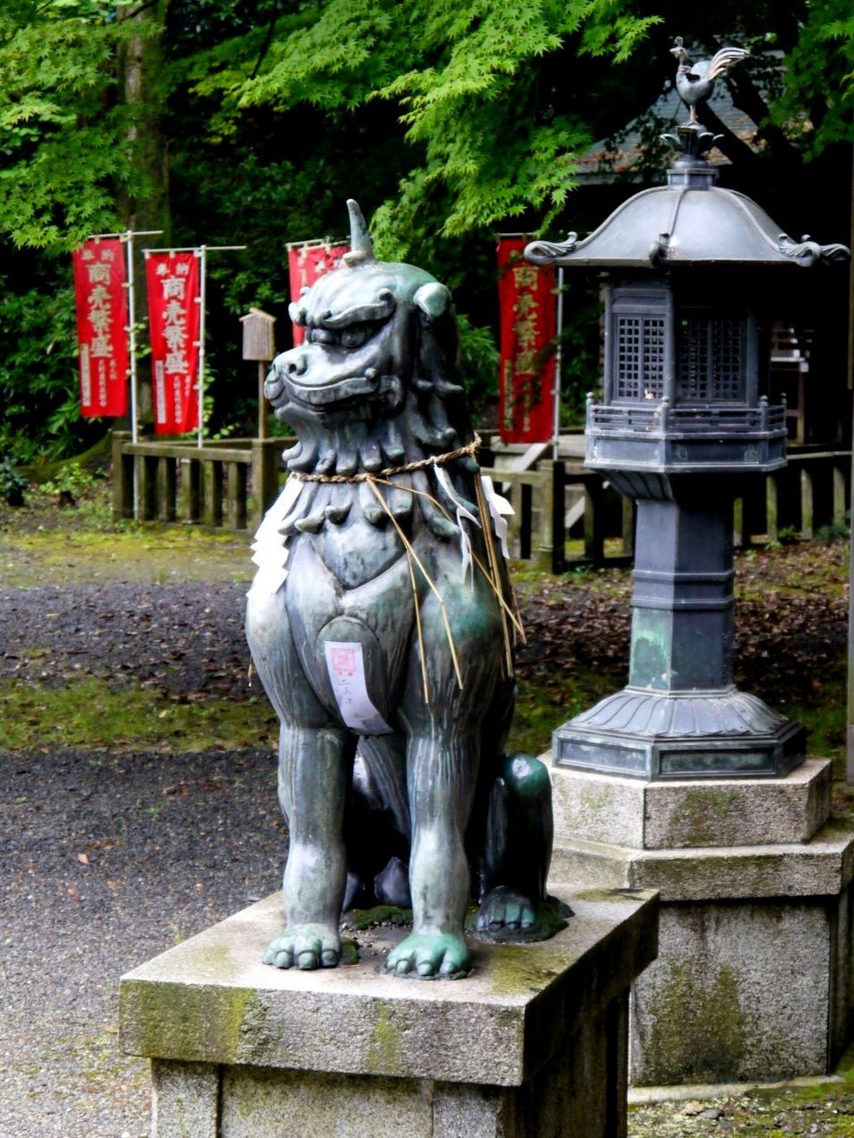 Statue of strange horned beast beside metal lantern