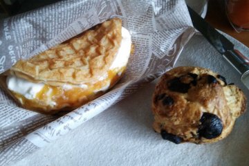 <p>Wani-waffle with peach compote and a chocolate scone.</p>