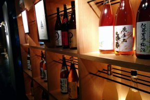 A wall of various sake, all of which are for sale on the drink menu.&nbsp;