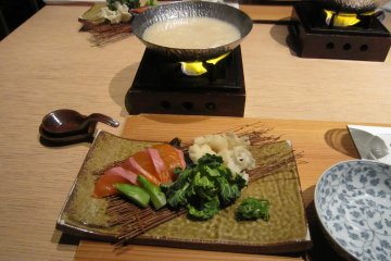 <p>Shabu-Shabu of cherry trout? and new brown seaweed. These white mushrooms are called &#39;Flower Petal mushroom&#39;. The soup is made of sake lees...how intricate!</p>