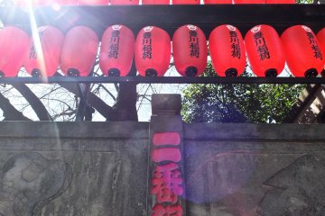 <p>Red lanterns adorning the outside wall of the temple</p>