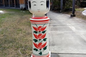 A plus-sized kokeshi doll welcomes you as you approach the front entrance.&nbsp;