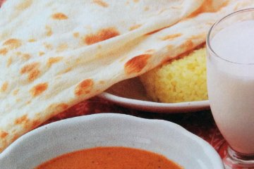 <p>A picture of a popular lunch set: naan bread and rice, curry, salad, and your choice of drink.&nbsp;</p>