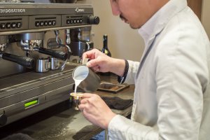 Miki Takamasa, a barista with 7 years of experience under his belt, pours a piccolo latte.