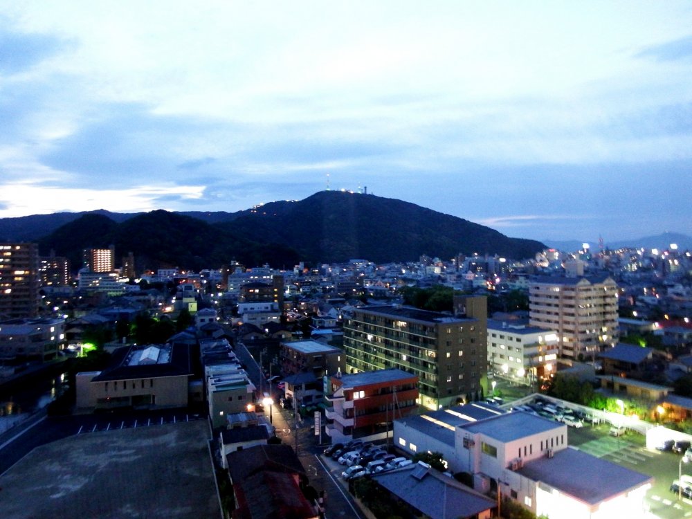Tokushima City at dusk, seen from Century Plaza Hotel Tokushima. The mountain in the background is Bi-zan, literary, eyebrow mountain