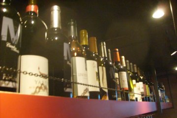 Wine stored on a shelf over the bar, safely out of the comedians&#39; reach