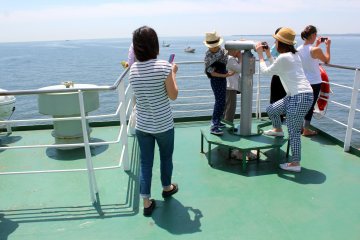 Enjoy the beautiful ocean views and peek through telescopes on the upper deck of the ferry.