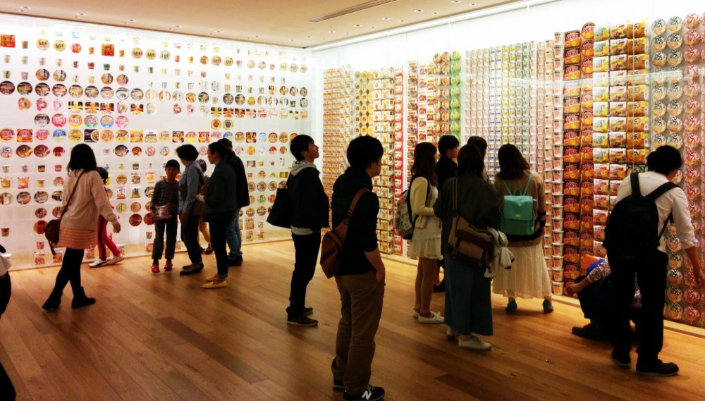 Visitors browse the walls of past instant noodle package designs.&nbsp;
