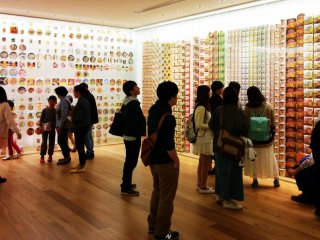 Visitors browse the walls of past instant noodle package designs.&nbsp;