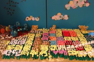 The field of flowers display which is filled with tiny origami flowers like tulips, daffodils, and more.