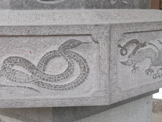 Carvings of the twelve zodiac animals around the base of a statue