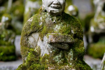 <p>Moss covered old statues of Kannon</p>