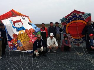 The local Kesennuma&nbsp;kite association poses proudly next to their oversized kites