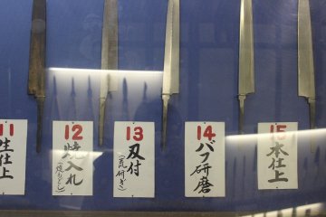 <p>The process of manufacturing Japanese kitchen knives is displayed on the wall.</p>