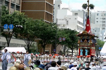 <p>The floats are pulled along by lines of strong men</p>
