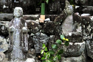 <p>Buddhist statues in a small cemetery</p>