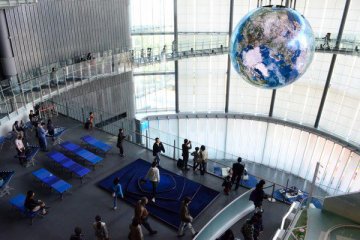 The giant globe floats between the two floors