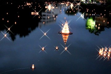 <p>Lanterns floating in the castle moat</p>