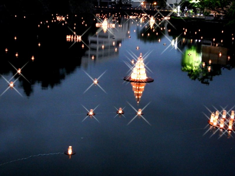 <p>Lanterns floating in the castle moat</p>