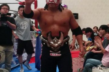 <p>The Great Sasuke retains the championship belt. He is very popular, partly because he throws candy to the children in the crowd before matches</p>