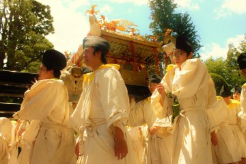 <p>Bearers of one of the three omikoshi or portable shrines that are seen in the procession. This one bears a phoenix, which represents the living spirit of the deified Tokugawa Iyasu. Each are intricately decorated in gold.</p>