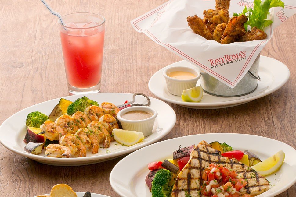 L-R: Grilled shrimp brochette, Sea Breeze cocktail,&nbsp;grilled swordfish (main), Cajun popcorn shrimp