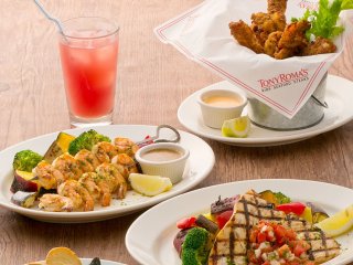 L-R: Grilled shrimp brochette, Sea Breeze cocktail,&nbsp;grilled swordfish (main), Cajun popcorn shrimp