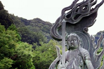 <p>The statue of Fudo-Myo-O with forest in the background</p>