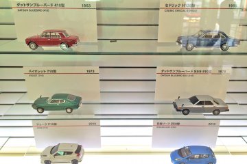 <p>A few of the Nissan miniature models showcased in a wall display</p>