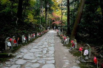 <p>Tiny Ojizo statues line both sides of the path</p>