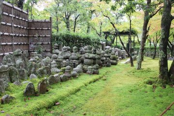 <p>Pass through the mountain gate and enter a small area inside where a mossy garden and stone Buddhist statues greet you</p>