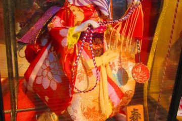 A Meiji era hina doll, still in its glass preservation case
