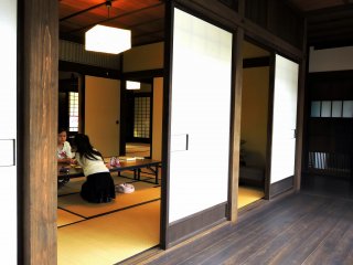 Two girls were taking a rest at a table on the tatami-mat floor