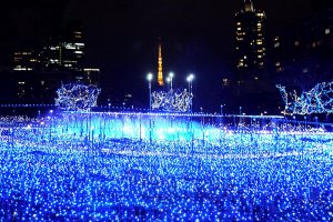 Tokyo Tower glows warmly behind a sea of LED blue